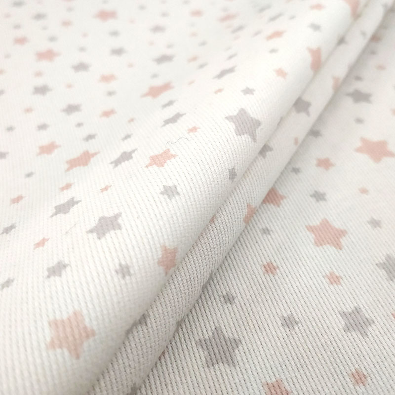 Tela de piqué de algodón con estampado de estrellas rosas