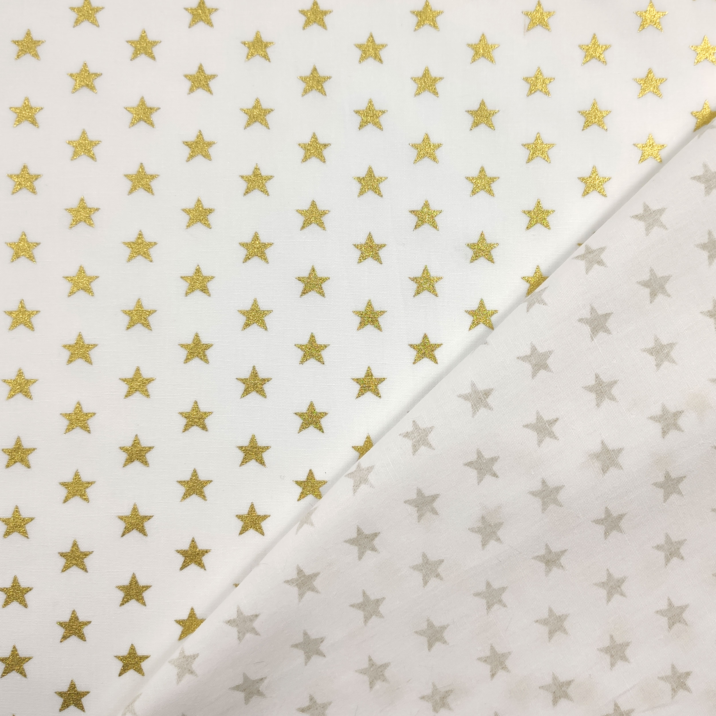 Tela de algodón Estrellas Lurex Fondo Dorado Blanco