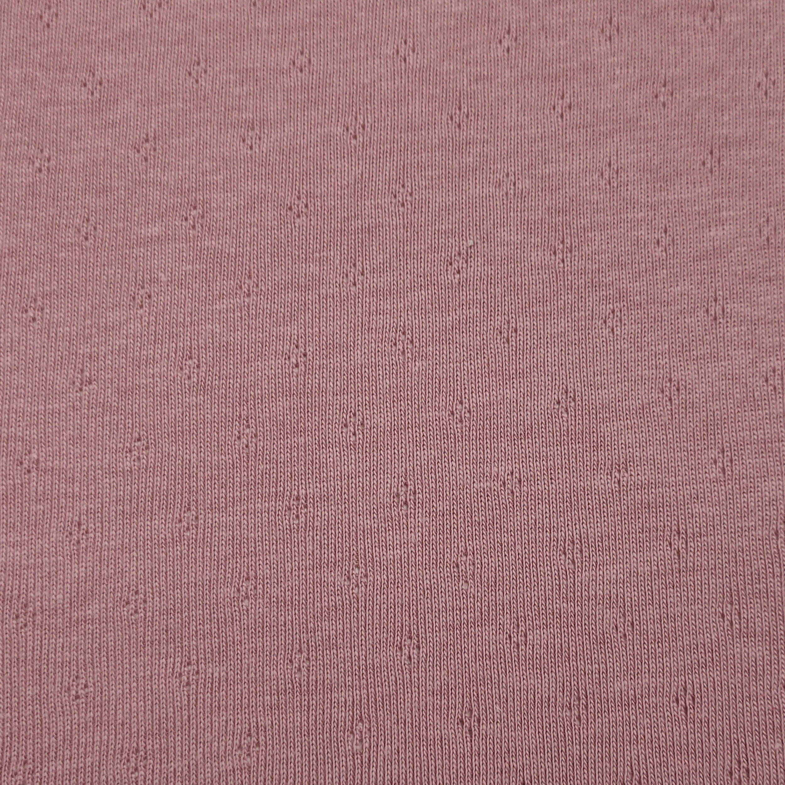 Jersey Cotton Jersey Perforated Flowers on a Pink Background Image