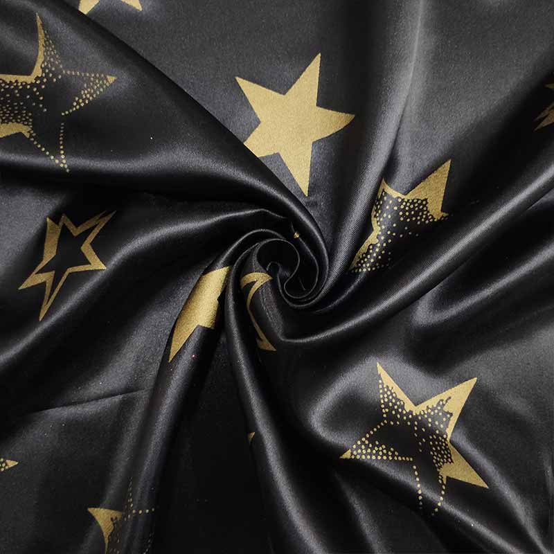Schwarzer Karnevals-Satin-Stoff mit goldenen Sternen