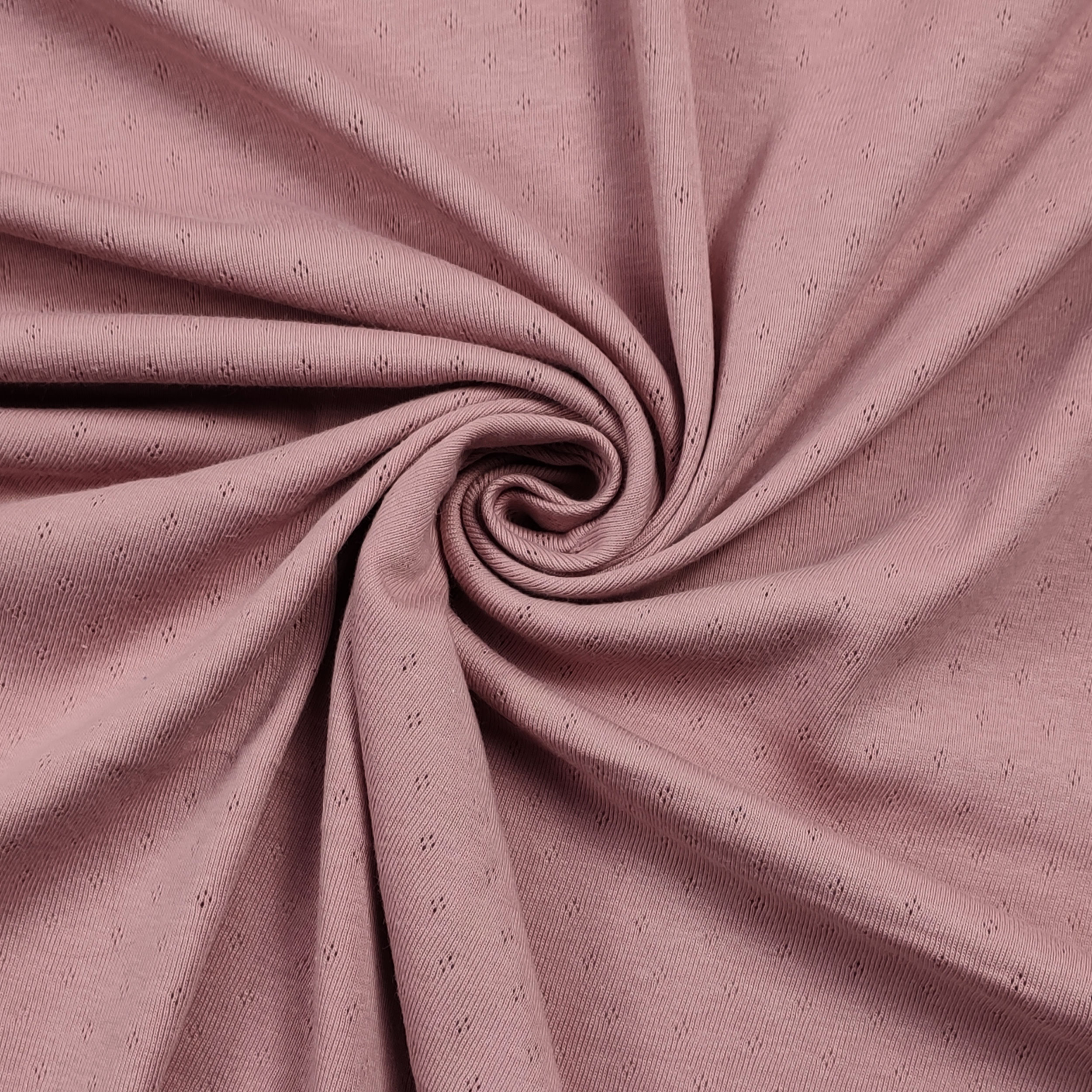 Jersey Cotton Jersey Perforated Flowers on a Pink Background Image