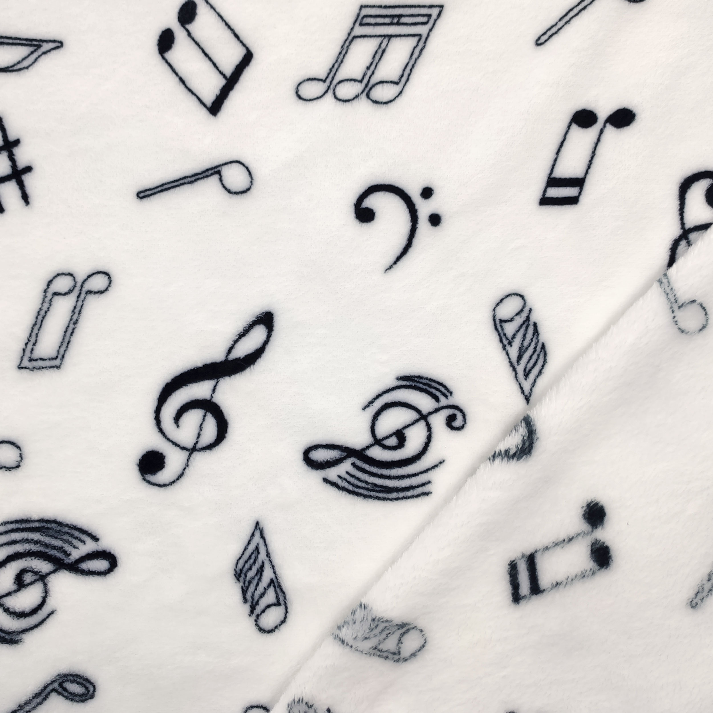 Vellón de cachemira blanco con notas musicales