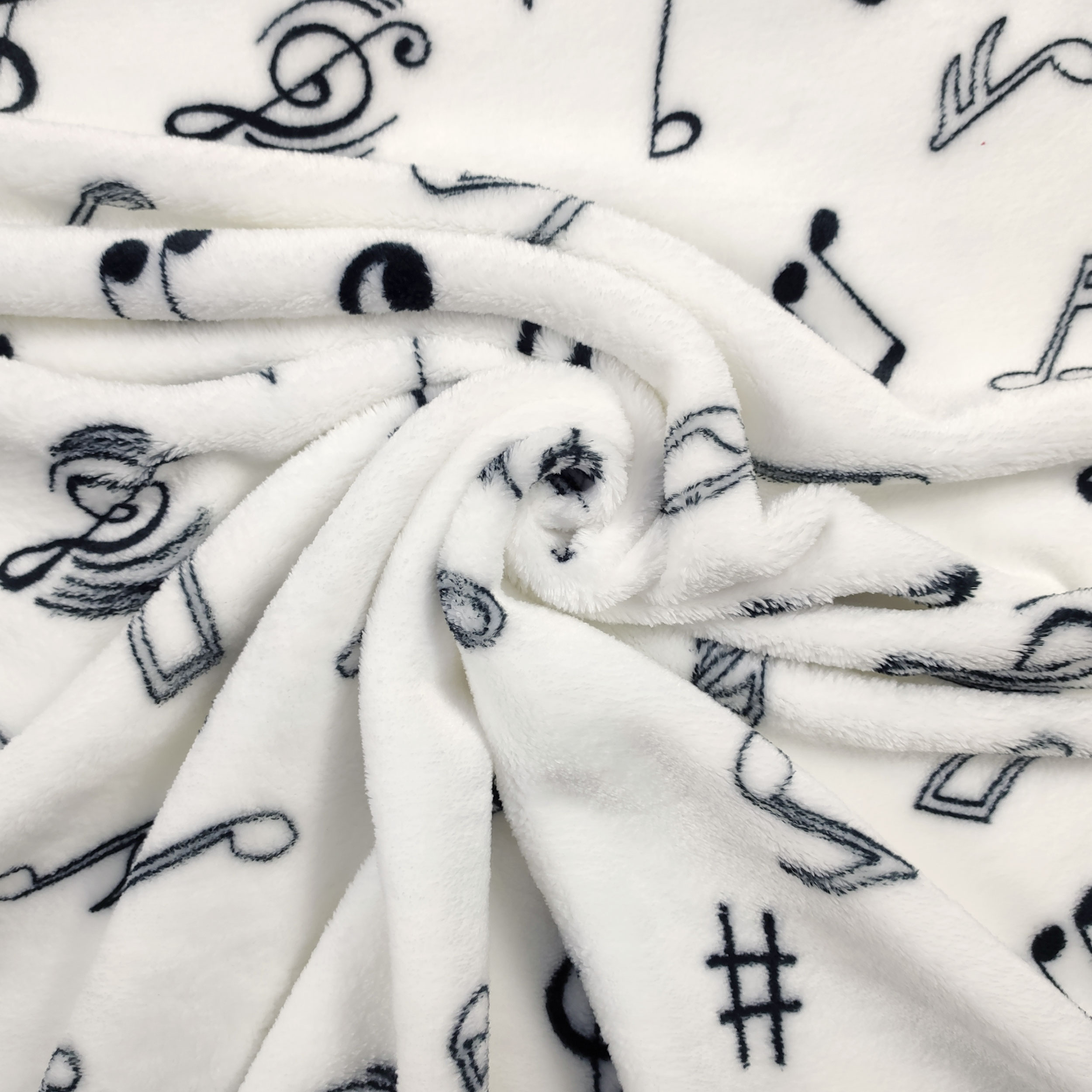 Vellón de cachemira blanco con notas musicales